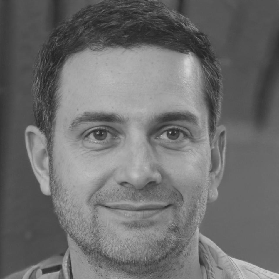 Professional portrait of David Ashworth reviewing financial documents